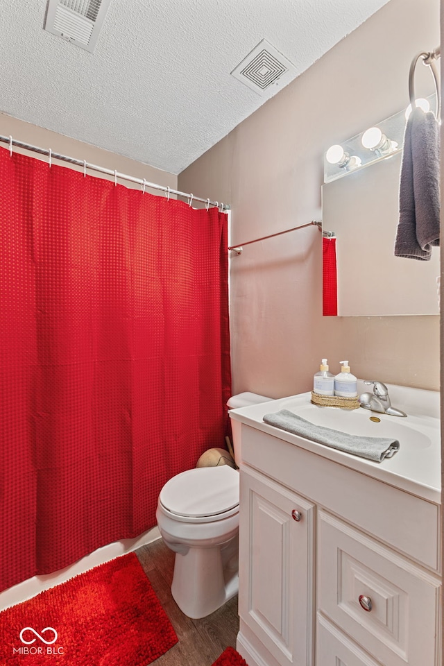 5115 Bertha St, Indianapolis, IN 46241 - bathroom featuring vanity, wood finished floors, toilet, a textured ceiling, and a shower with shower curtain