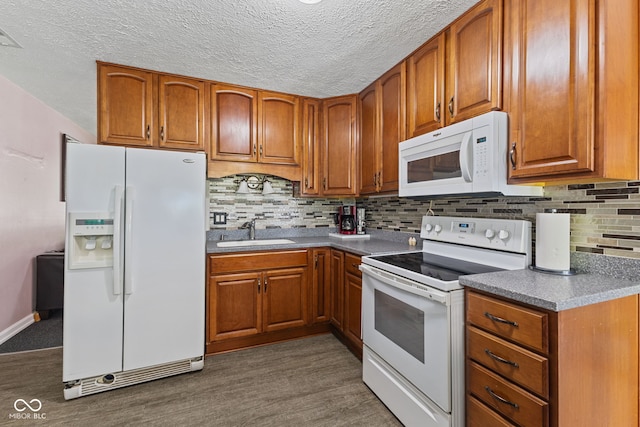 5115 Bertha St, Indianapolis, IN 46241 - kitchen with white appliances, a sink, brown cabinetry, decorative backsplash, and a textured ceiling