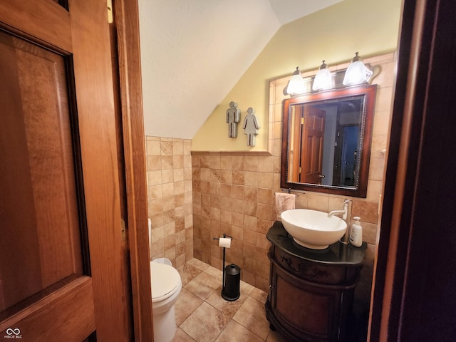 1026 Summer Way Dr, Shelbyville, IN 46176 - half bathroom featuring lofted ceiling, tile walls, vanity, toilet, and tile patterned floors