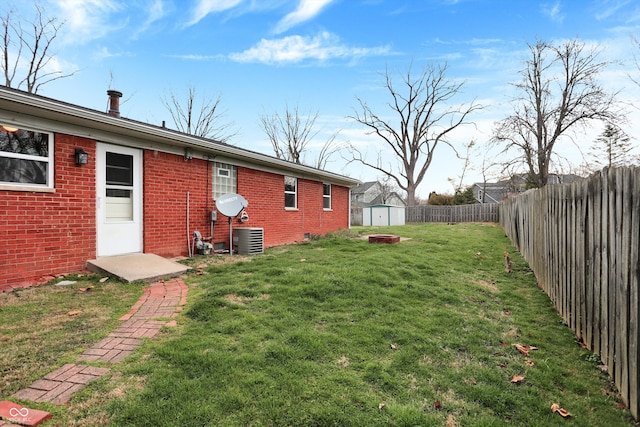 rear view of house with brick siding, a storage shed, cooling unit, and an outdoor structure