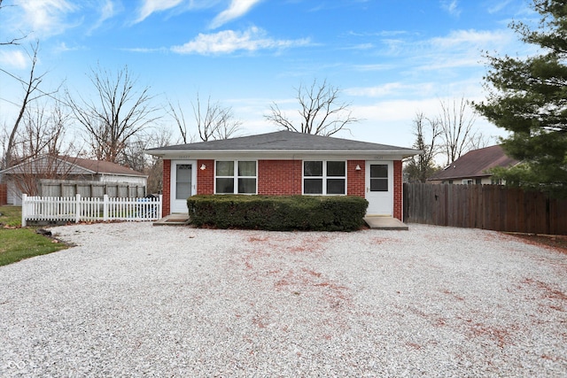 view of front of property featuring driveway and brick siding