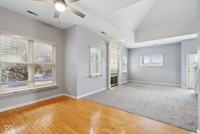 455 S Pine St Unit 4, Indianapolis, IN 46203 - unfurnished living room with ceiling fan, a tile fireplace, baseboards, light wood-style flooring, and vaulted ceiling
