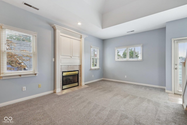 455 S Pine St Unit 4, Indianapolis, IN 46203 - unfurnished living room with light carpet, healthy amount of natural light, a tiled fireplace, and recessed lighting