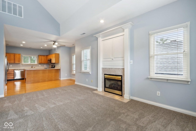 455 S Pine St Unit 4, Indianapolis, IN 46203 - unfurnished living room with light carpet, ceiling fan, vaulted ceiling, a fireplace, and baseboards