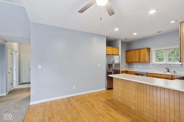 455 S Pine St Unit 4, Indianapolis, IN 46203 - kitchen featuring stainless steel appliances, light countertops, light wood-style floors, a ceiling fan, and a sink