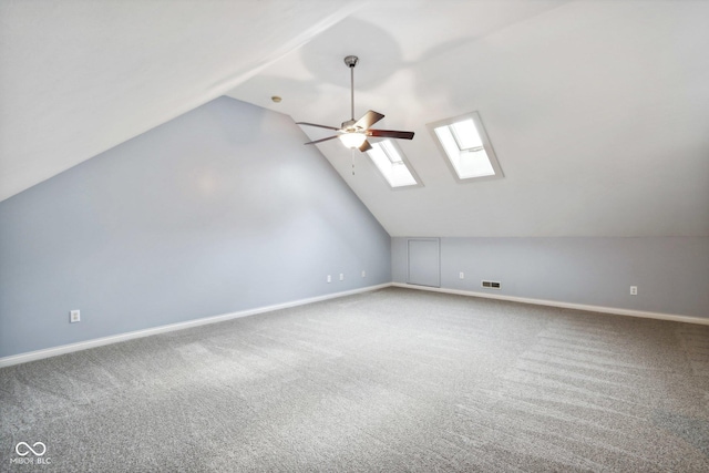 455 S Pine St Unit 4, Indianapolis, IN 46203 - additional living space with a skylight, vaulted ceiling, ceiling fan, carpet floors, and baseboards