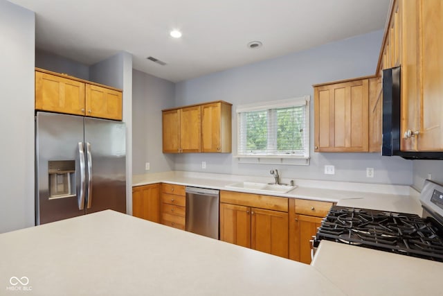 455 S Pine St Unit 4, Indianapolis, IN 46203 - kitchen featuring appliances with stainless steel finishes, a sink, light countertops, and recessed lighting