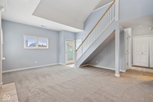 455 S Pine St Unit 4, Indianapolis, IN 46203 - unfurnished living room with carpet, baseboards, and stairs
