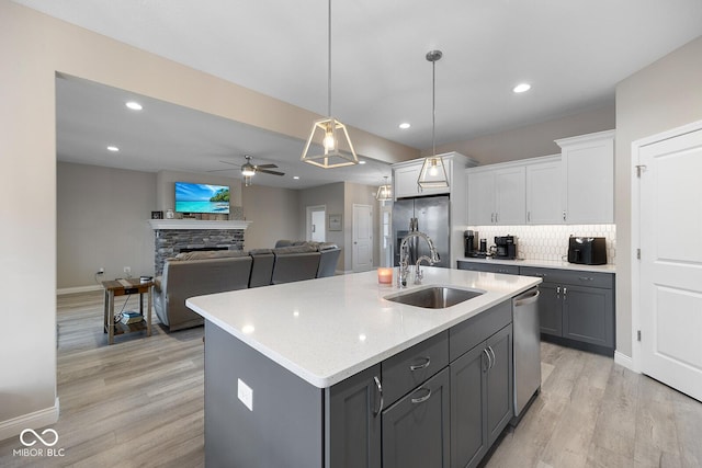 3583 Collier Dr, Lafayette, IN 47905 - kitchen featuring a sink, stainless steel appliances, white cabinetry, gray cabinetry, and light wood-type flooring