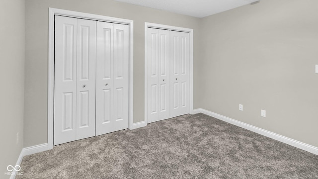 3583 Collier Dr, Lafayette, IN 47905 - unfurnished bedroom featuring multiple closets, carpet floors, and baseboards