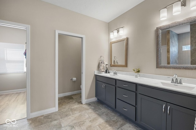 3583 Collier Dr, Lafayette, IN 47905 - full bathroom with baseboards, toilet, and double vanity