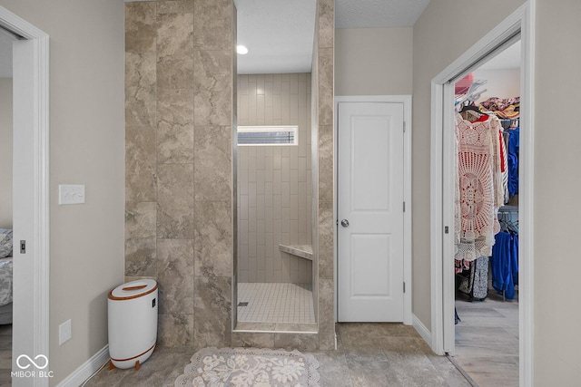 3583 Collier Dr, Lafayette, IN 47905 - bathroom featuring a walk in shower, baseboards, and a walk in closet