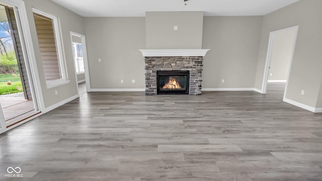 3583 Collier Dr, Lafayette, IN 47905 - unfurnished living room with plenty of natural light, a fireplace, and wood finished floors