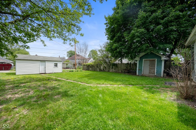 view of yard featuring a storage shed and an outbuilding