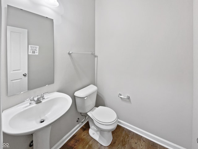 1276 Sanderling Dr, Greenwood, IN 46143 - half bath with baseboards, a sink, toilet, and wood finished floors