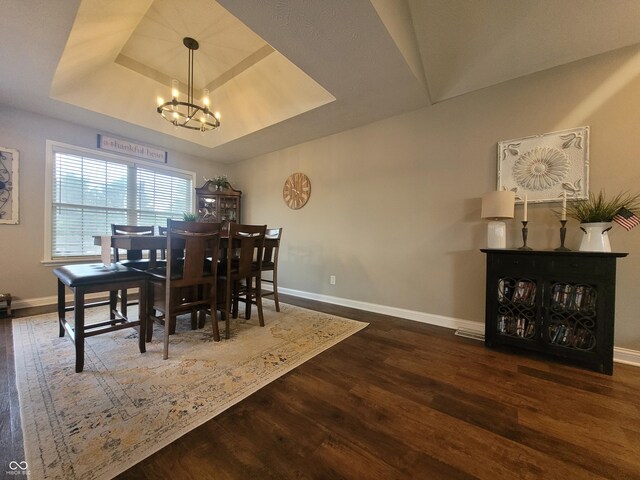 1714 Michelle Mnr, Danville, IN 46122 - dining space featuring a tray ceiling, a chandelier, wood finished floors, and baseboards