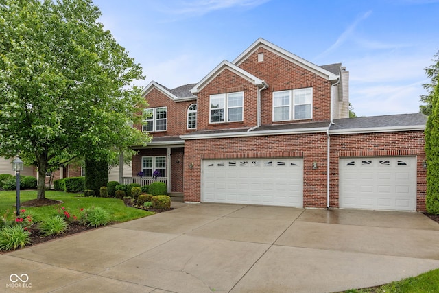 3449 Brixford Ln, West Lafayette, IN 47906 - traditional home with driveway, an attached garage, brick siding, and a front yard