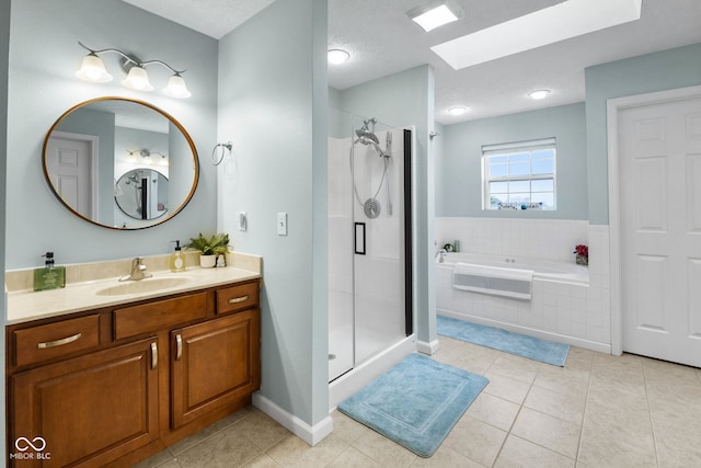 3449 Brixford Ln, West Lafayette, IN 47906 - bathroom featuring a skylight, a bath, vanity, a shower stall, and tile patterned flooring