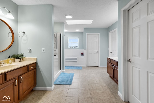 3449 Brixford Ln, West Lafayette, IN 47906 - full bathroom with a skylight, vanity, baseboards, a stall shower, and a bath