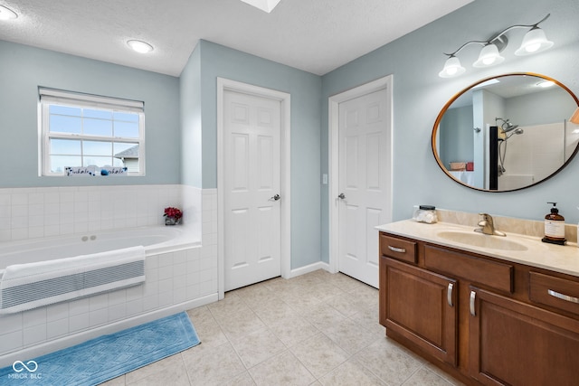 3449 Brixford Ln, West Lafayette, IN 47906 - bathroom featuring vanity, a bath, tile patterned floors, a textured ceiling, and baseboards