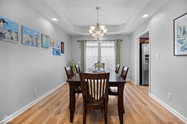 3449 Brixford Ln, West Lafayette, IN 47906 - dining space featuring a chandelier, a raised ceiling, light wood finished floors, baseboards, and recessed lighting