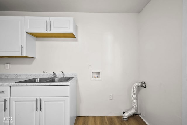 611 Hampton Ln, Anderson, IN 46017 - laundry area featuring cabinet space, washer hookup, and wood finished floors