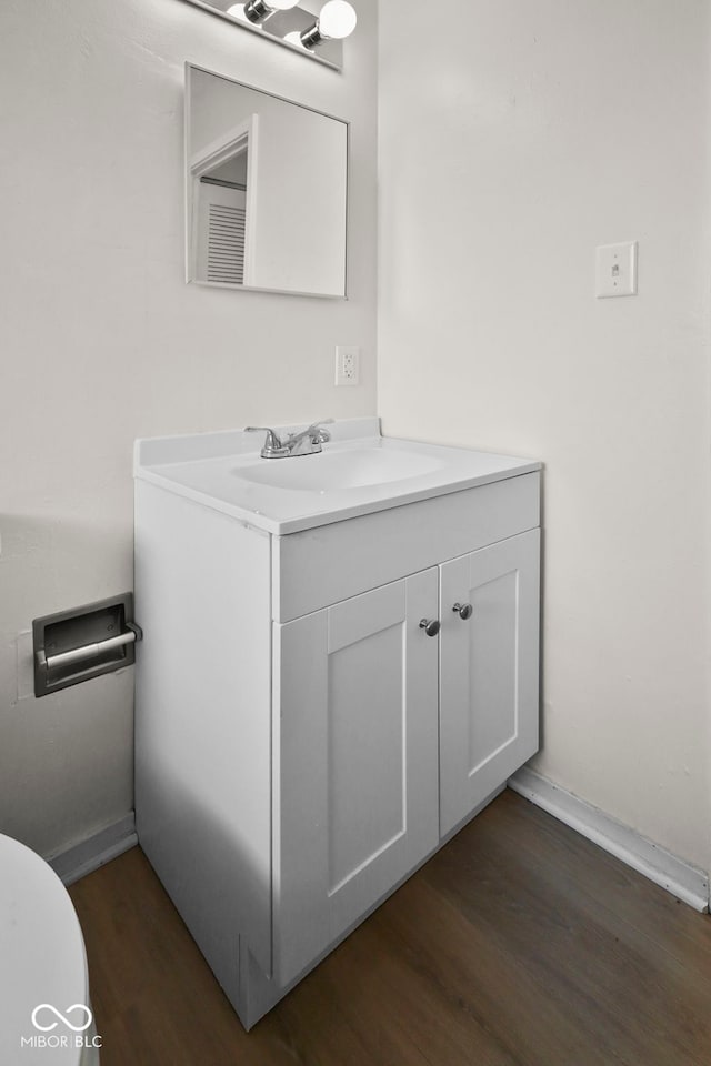611 Hampton Ln, Anderson, IN 46017 - bathroom with wood finished floors, vanity, toilet, and baseboards