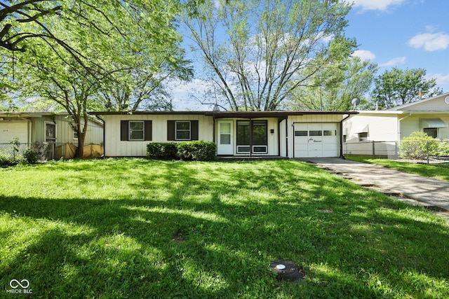 611 Hampton Ln, Anderson, IN 46017 - single story home with an attached garage, concrete driveway, and board and batten siding