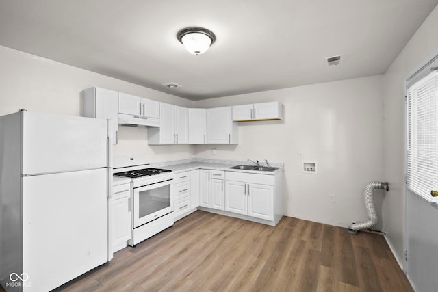 611 Hampton Ln, Anderson, IN 46017 - kitchen featuring white appliances, under cabinet range hood, a sink, and white cabinets