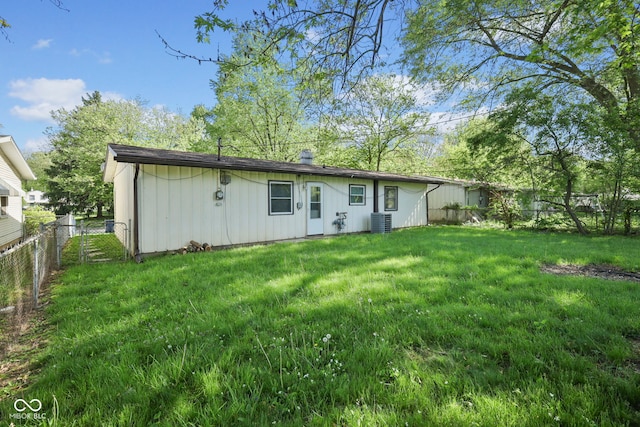 611 Hampton Ln, Anderson, IN 46017 - rear view of property with central AC unit, board and batten siding, and a chimney