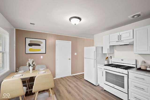 611 Hampton Ln, Anderson, IN 46017 - kitchen featuring white appliances, under cabinet range hood, white cabinetry, and light wood-style floors