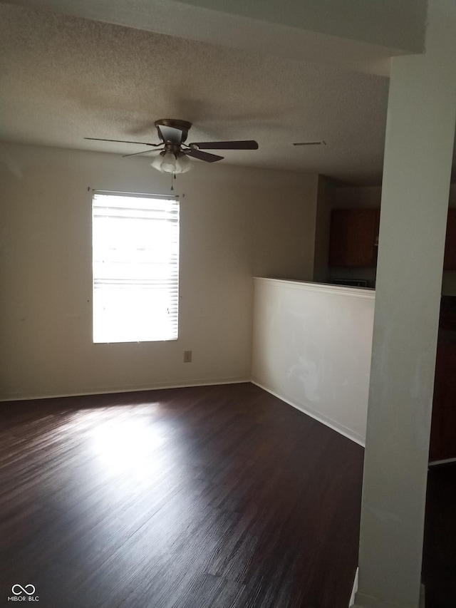 10795 Albertson Dr, Indianapolis, IN 46231 - unfurnished room featuring dark wood finished floors, a ceiling fan, a textured ceiling, and baseboards
