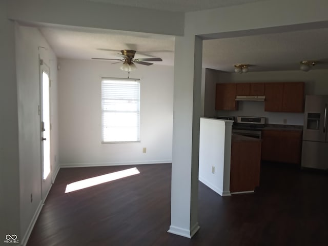 10795 Albertson Dr, Indianapolis, IN 46231 - kitchen with white refrigerator with ice dispenser, dark countertops, brown cabinetry, dark wood-style floors, and stainless steel range with electric cooktop