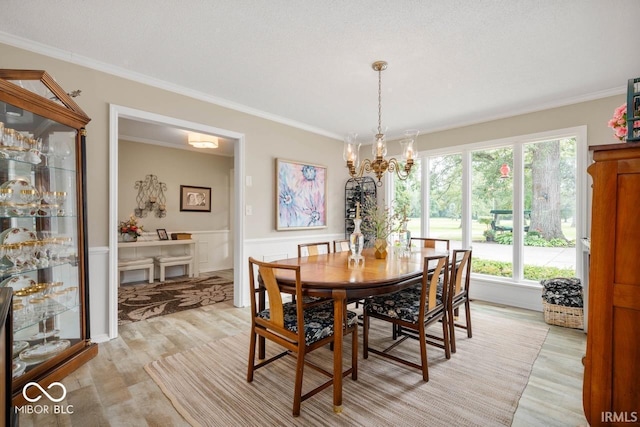 3000 E County Road 400 N, Muncie, IN 47303 - dining space featuring light wood finished floors, ornamental molding, a wainscoted wall, and a chandelier