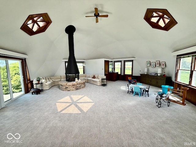 3000 E County Road 400 N, Muncie, IN 47303 - living room with carpet flooring, healthy amount of natural light, ceiling fan, high vaulted ceiling, and a wood stove