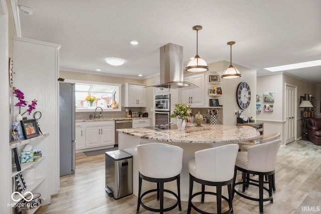 3000 E County Road 400 N, Muncie, IN 47303 - kitchen featuring island range hood, appliances with stainless steel finishes, a sink, ornamental molding, and tasteful backsplash
