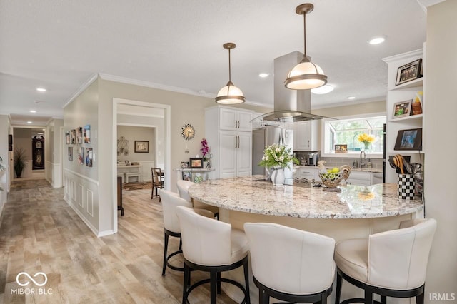 3000 E County Road 400 N, Muncie, IN 47303 - kitchen with freestanding refrigerator, a peninsula, a kitchen breakfast bar, ornamental molding, and light stone counters