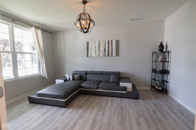 4863 Sherlock Dr, Westfield, IN 46062 - living area featuring wood finished floors, baseboards, and a chandelier