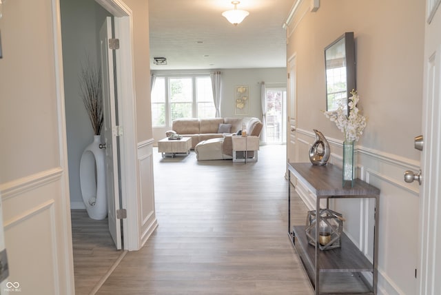 4863 Sherlock Dr, Westfield, IN 46062 - hallway featuring wood finished floors, a decorative wall, and a wainscoted wall