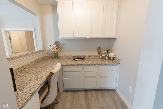 4863 Sherlock Dr, Westfield, IN 46062 - kitchen with light wood finished floors, white cabinets, and light stone counters