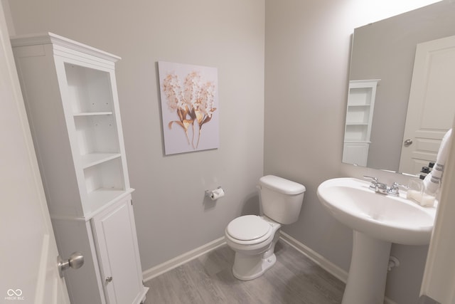 4863 Sherlock Dr, Westfield, IN 46062 - bathroom featuring baseboards, wood finished floors, toilet, and a sink