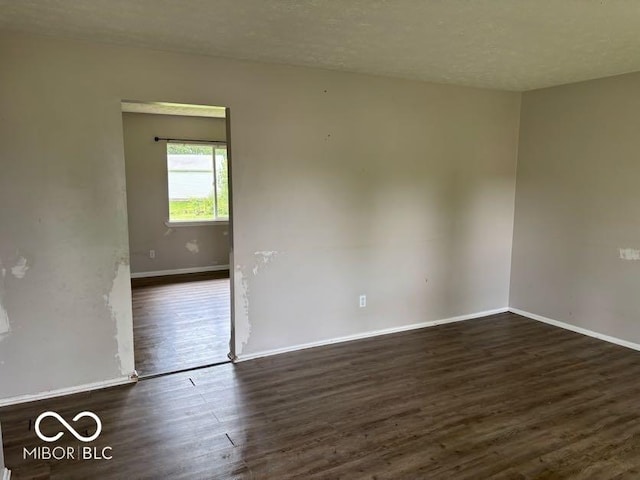 1002 Brookside Ln, Plainfield, IN 46168 - empty room with dark wood-style flooring and baseboards