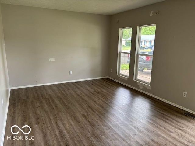 1002 Brookside Ln, Plainfield, IN 46168 - unfurnished room featuring dark wood-style flooring and baseboards