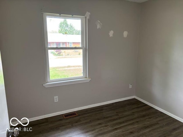 1002 Brookside Ln, Plainfield, IN 46168 - unfurnished room featuring plenty of natural light, dark wood-style floors, and baseboards