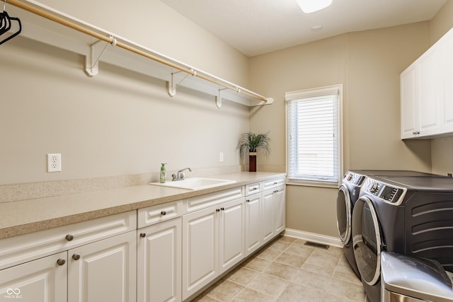 10784 Giselle Way, Fishers, IN 46040 - laundry room featuring cabinet space, washer and clothes dryer, baseboards, and light tile patterned floors