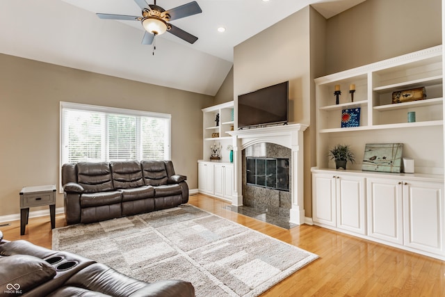 10784 Giselle Way, Fishers, IN 46040 - living area with ceiling fan, a premium fireplace, light wood-type flooring, lofted ceiling, and recessed lighting