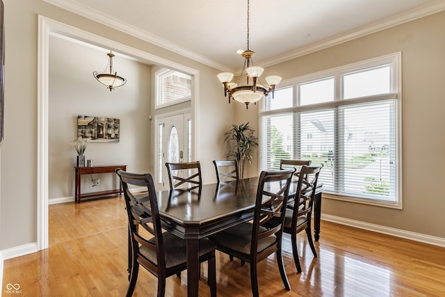 10784 Giselle Way, Fishers, IN 46040 - dining room featuring healthy amount of natural light, a chandelier, ornamental molding, light wood finished floors, and baseboards