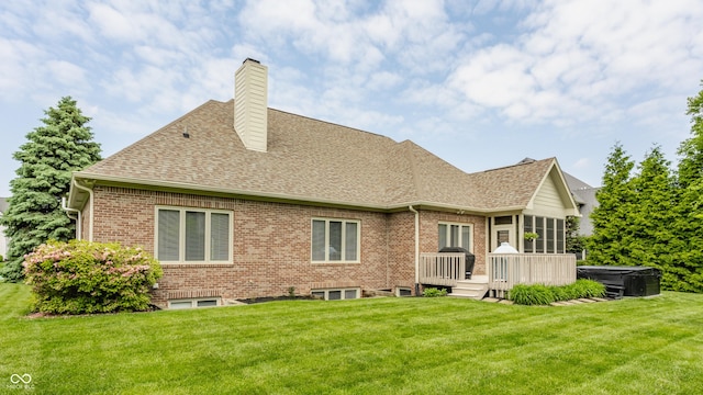 10784 Giselle Way, Fishers, IN 46040 - back of house featuring brick siding, roof with shingles, a hot tub, and a lawn
