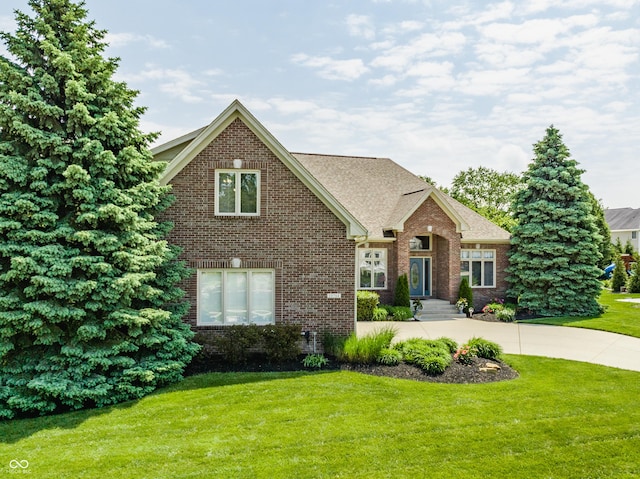 10784 Giselle Way, Fishers, IN 46040 - view of front of home with brick siding, a front lawn, and a shingled roof
