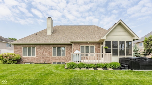 10784 Giselle Way, Fishers, IN 46040 - back of house with a hot tub, a sunroom, roof with shingles, a chimney, and a lawn